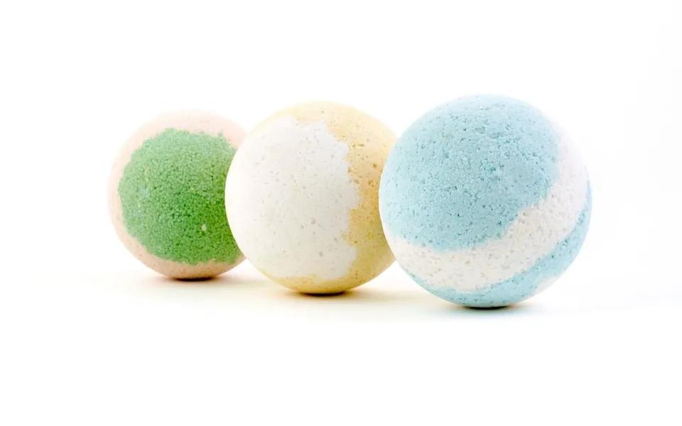 Three pastel bath bombs on white