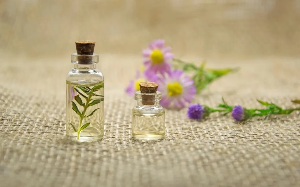 Small corked glass bottles with botanicals on linen
